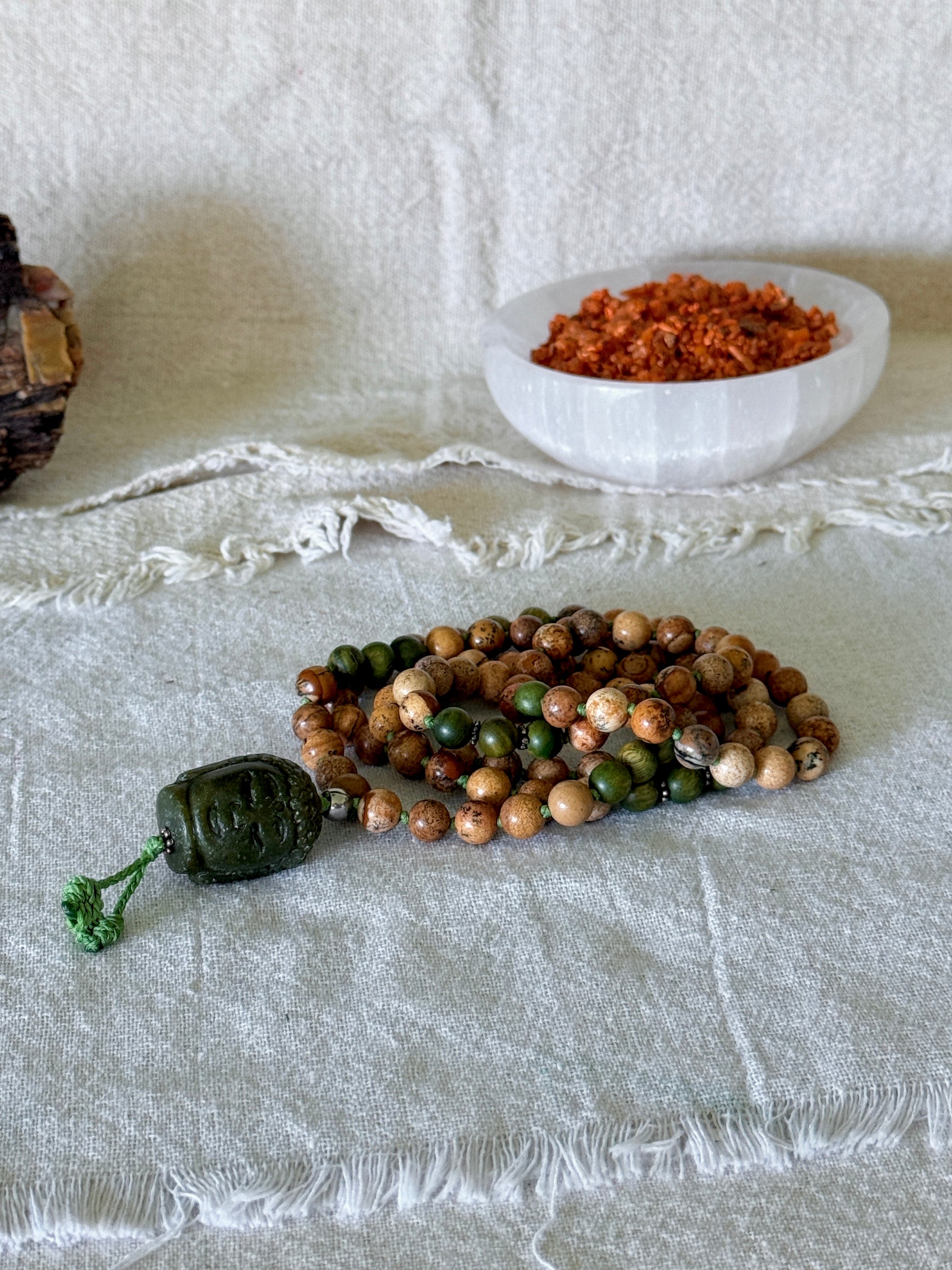 Handmade spiritual jewelry with sacred sandalwood beads, sand jasper, silver details, and Jade Buddha meru