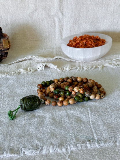 Handmade spiritual jewelry with sacred sandalwood beads, sand jasper, silver details, and Jade Buddha meru