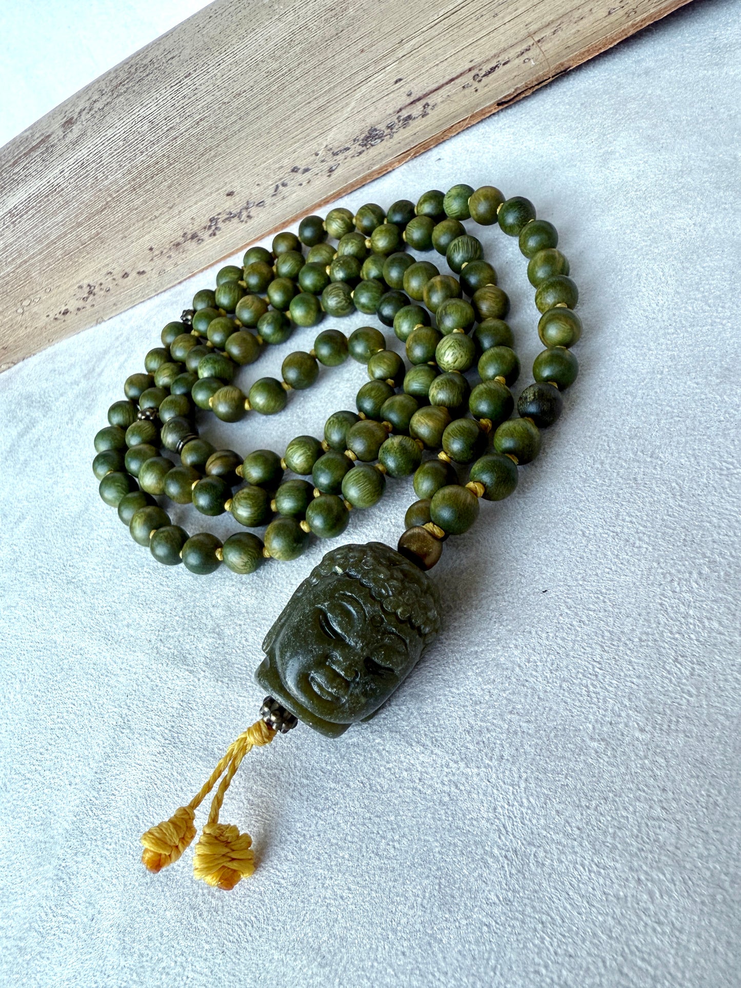 Spiritual sandalwood mala necklace for calm, compassion, and heart-centered awareness