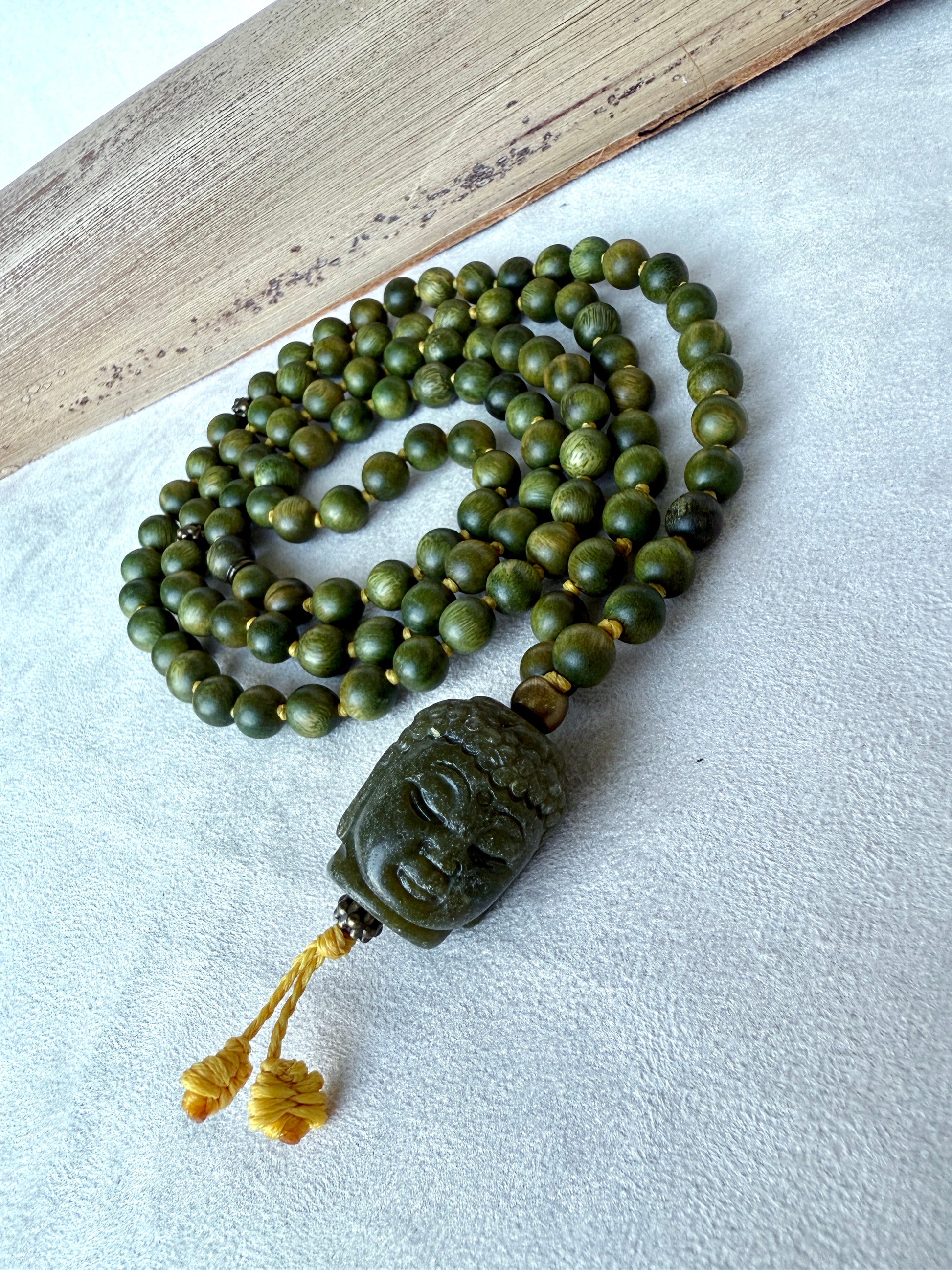 Spiritual sandalwood mala necklace for calm, compassion, and heart-centered awareness