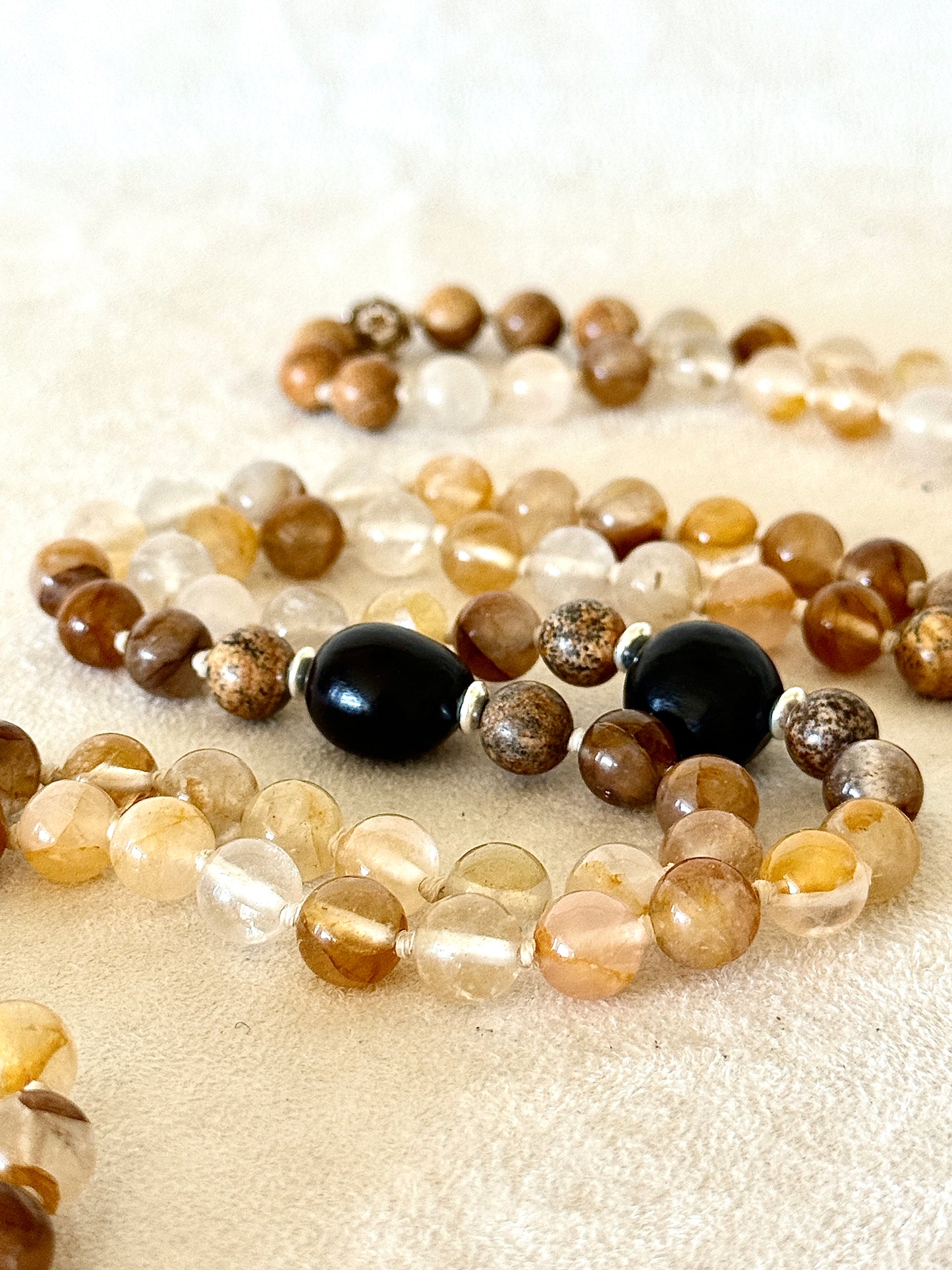 close up of soapberry seeds on a handmade mala necklace by Samdea