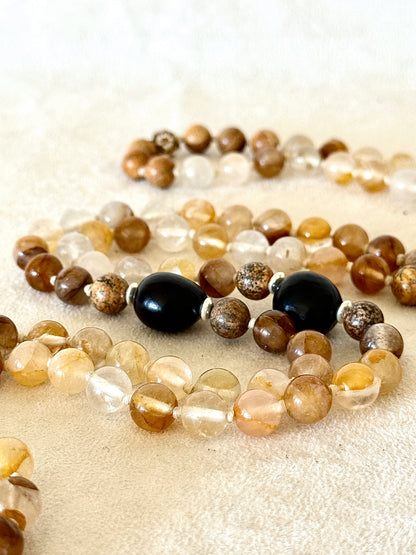 close up of soapberry seeds on a handmade mala necklace by Samdea