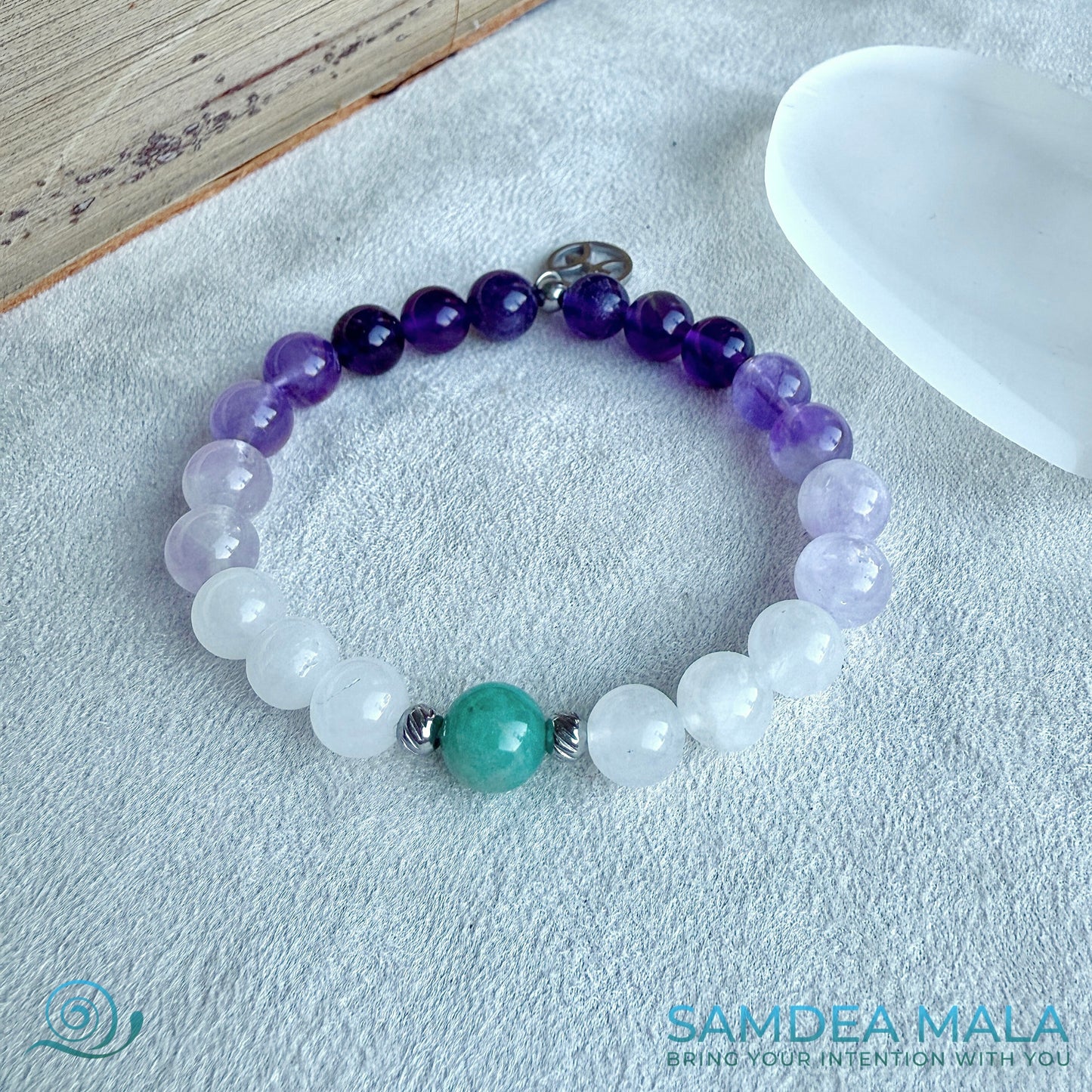 Samdea Mala zodiac-inspired mala bracelet featuring purple amethyst, lavender jade, white jade, and amazonite. A small Pisces charm completes the design.