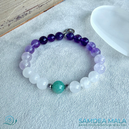 Samdea Mala zodiac-inspired mala bracelet featuring purple amethyst, lavender jade, white jade, and amazonite. A small Pisces charm completes the design.